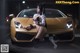 A woman sitting on the hood of a gold sports car.