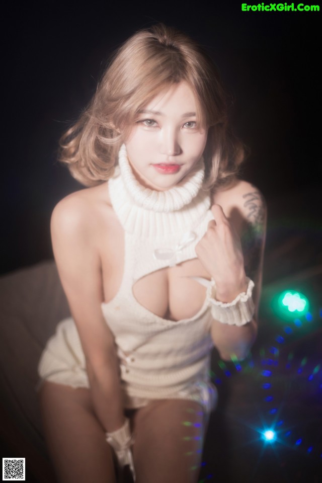 A woman in a white dress posing for a picture.